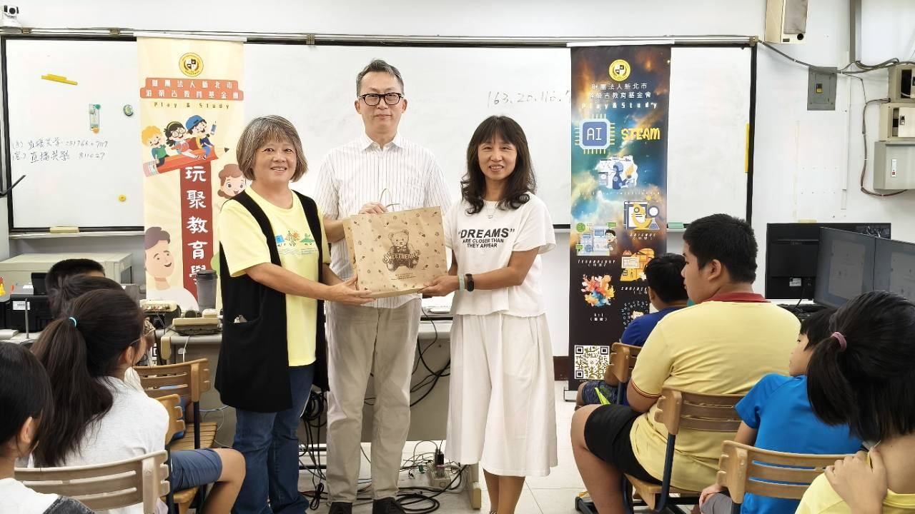 橫山國小 AI x 3D 電腦動漫課始業式中,師長於學生面前合影並致贈禮品