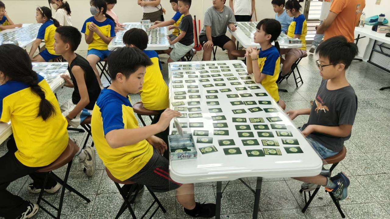 坪林國小學生在桌面上操作部件獸桌遊卡片